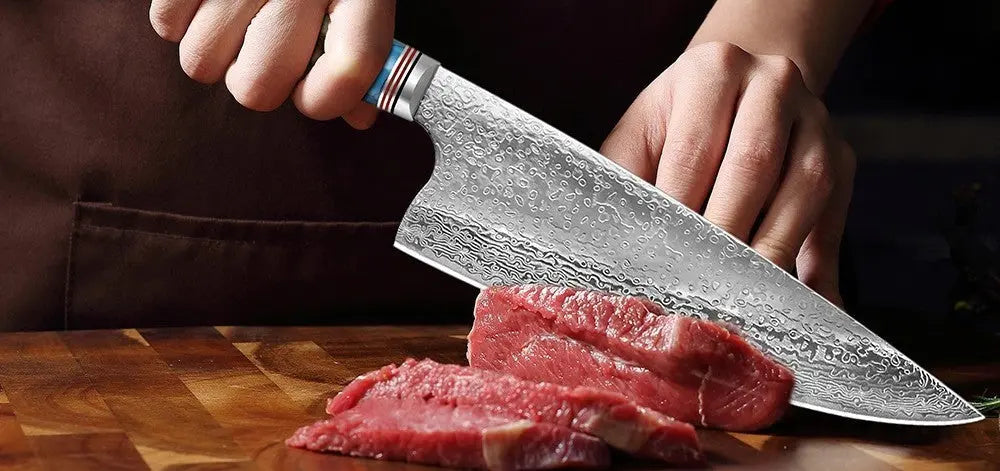 Image of Hand using a Damascus chef knife from BlackSteel Cutlery to slice raw meat on a wooden board